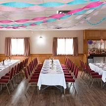 Newmarket Inn | East Gwillimbury, Ontario, L9N 0J2 | Meeting room tables with red chairs and blue and pink streamers hanging